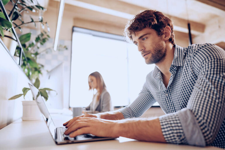 Two business people working at their computers