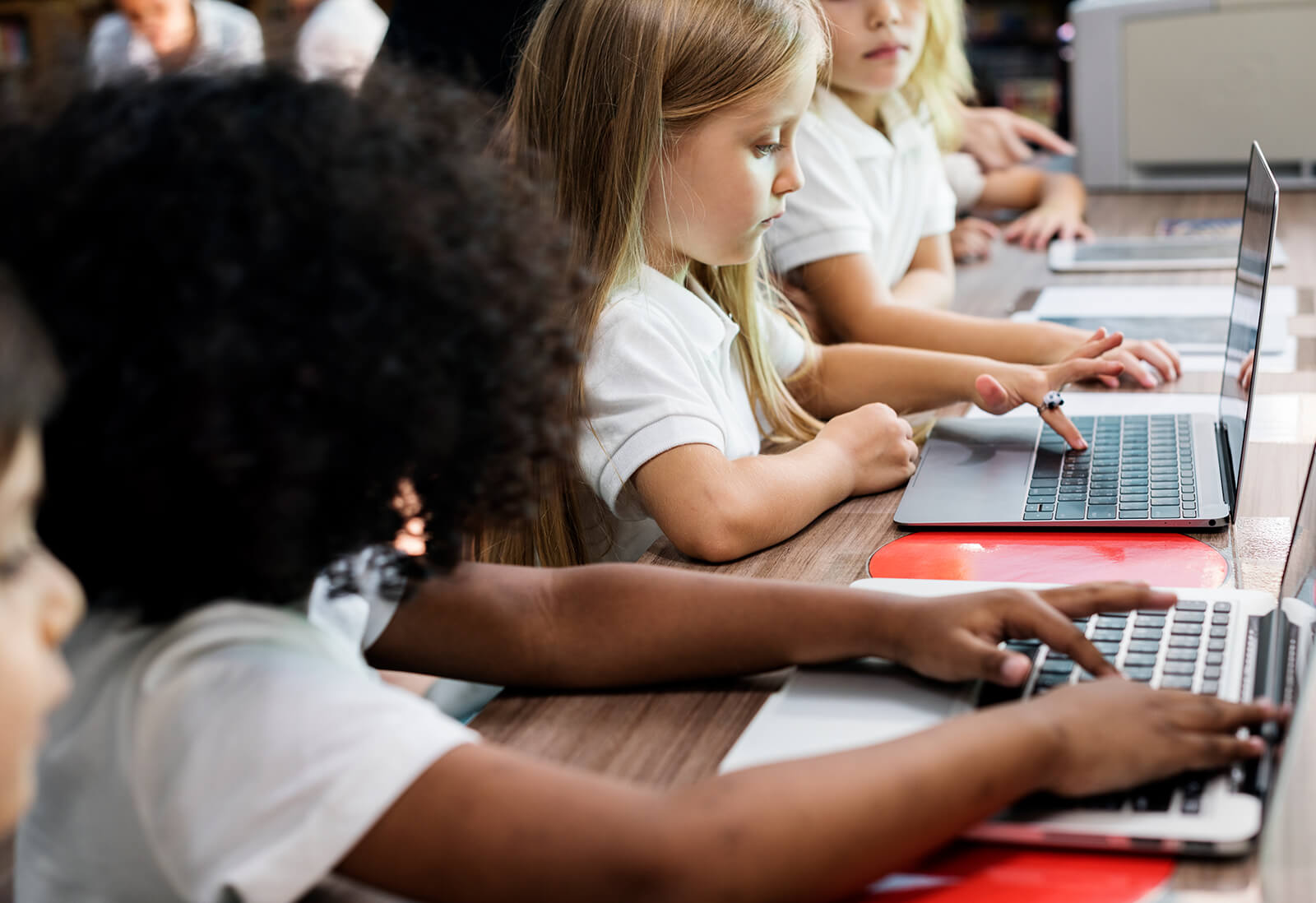 School kids studying in front of computers